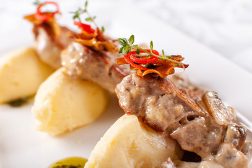 Pork Medallions with Mashed Potato and Mushrooms. Pork tenderloin on a white plate, good serving. restaurant menu