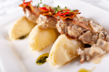 Pork Medallions with Mashed Potato and Mushrooms. Pork tenderloin on a white plate, good serving. restaurant menu