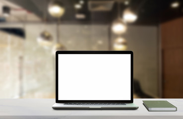 Laptop with blank screen on table.