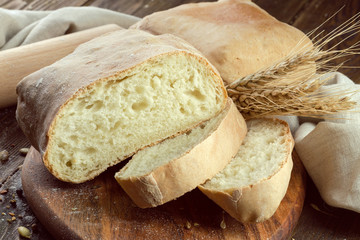baked bread on wooden table background