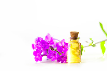 Essence of flowers on table in beautiful glass jar