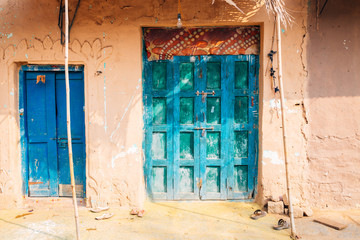 Old traditional clay house and colorful door in India