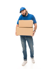 young delivery man holding cardboard boxes and talking by smartphone isolated on white