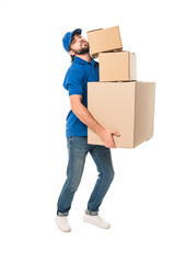 full length view of tired delivery man holding stacked cardboard boxes and looking at camera isolated on white