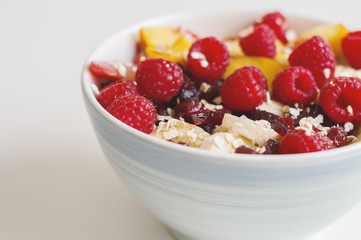 Fruit salad with raspberry, nectarine, banana, plum, dried cranberry and oats. Oats porridge with fruits and berries. Healthy eating concept