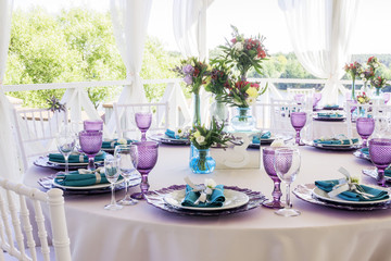 Fototapeta na wymiar Wedding decoration. Wedding table decor in lavender and emerald