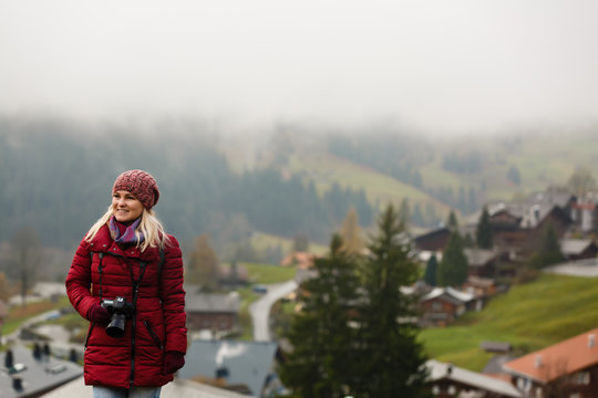 Beautiful girl photographer taking photos in the Swiss mountains. Switzerland.