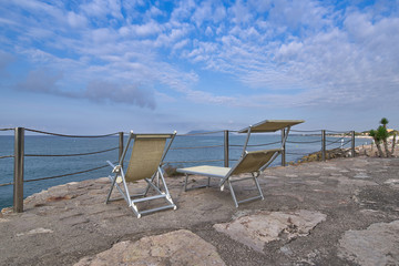 sandy beach along the sea, bathing people and playing children