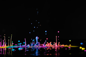 Abstract sculptures of colorful splashes of paint. Dancing liquid on a black background. Ink water...