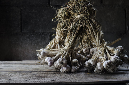 garlic and cove on wood background still life 