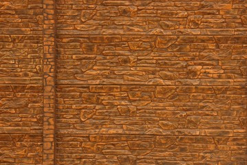 brown stone texture from the base of the wall of the fence