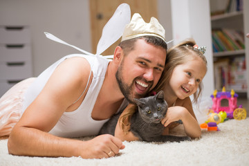 Little daughter and father have fun, dressing in princess costume, daddy makeup - obrazy, fototapety, plakaty