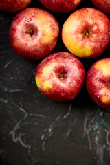 Fresh organic red apples on black background.