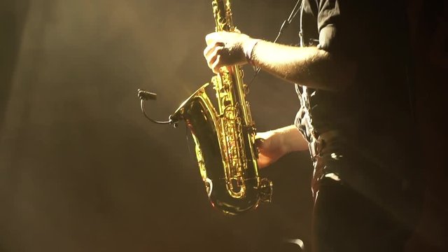 Slow motion of a saxophonist playing during a concert. saxophonist play jazz on golden saxophone, live music performance