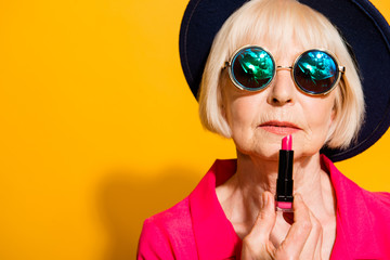 Makeup Time! Granny colors the lips holding red lipstick isolate - obrazy, fototapety, plakaty