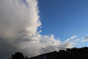 Fototapeta na wymiar Storm clouds move away over house
