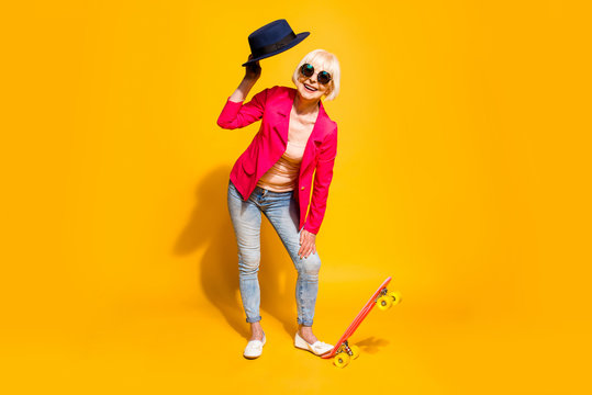 Full-body full-legh portrait of happy granny with a board for sk