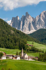 Fototapeta na wymiar The famous Church of Santa Maddelena against the backdrop of the Italian Dolomites on a summer afternoon.