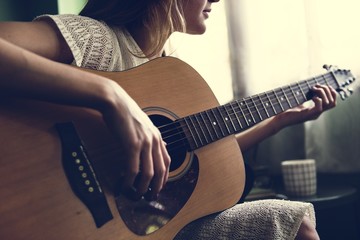 Girl playing an acoustic guitar