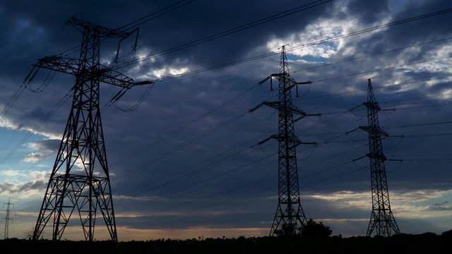 Timelapse of electricity pylon with stormy sky on the background. Evening 4K