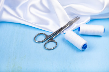 Sewing accessories on a blue  background