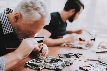 Two Men Repairing Hardware Equipment from PC.