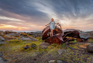 Female exploring rusting shipwrecks along Australian coast