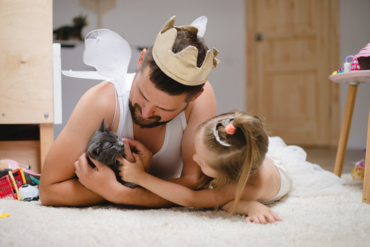 Little daughter and father have fun, dressing in princess costume, daddy makeup