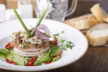 Munich salad. Bavarian salad with  pieces of fried sausage and bacon