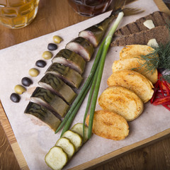 Appetizer with mackere and  baked potato. Tasty snack for beer