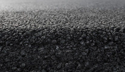Close-up on a layer of new asphalt at the road under construction.