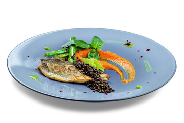Delicious grilled seabass fish fillet steak with vegetables. Healthy meal made of seafood fish and vegetables isolated on white background.