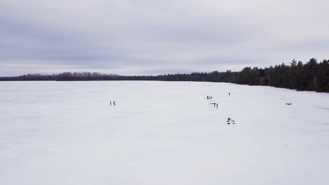 Get an aerial view of Ice Fishing on Fitzgerald Pond, Maine. Here we pass by many small groups.