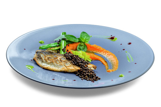 Delicious grilled seabass fish fillet steak with vegetables. Healthy meal made of seafood fish and vegetables isolated on white background.