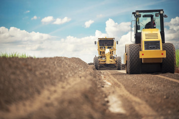 Motor Grader Civil Construction improvement base road work - Powered by Adobe