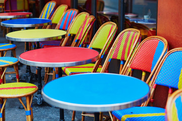 Colorful tables and chairs of outdoor cafe in Paris