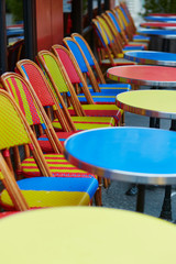 Colorful tables and chairs of outdoor cafe in Paris