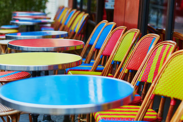 Colorful tables and chairs of outdoor cafe in Paris