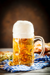 Beer mugs and pretzels on a wooden table. Oktoberfest. Beer festival.
