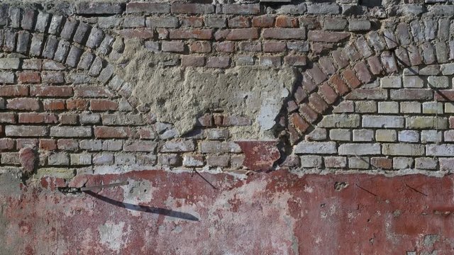 An old brick wall moves from right to left