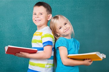 Little school child read books on blackboard