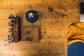 Working equipment and tools of a goldsmith on wooden desk as background