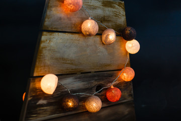 Christmas garland in the form of large colored balls on a black background.