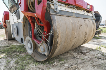 Red Heavy Vibration roller at asphalt pavement works. Road repairing. Road construction and...