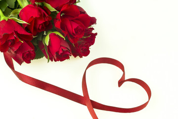 Romantic bouquet of red roses on a white background with a ribbon in the shape of a heart