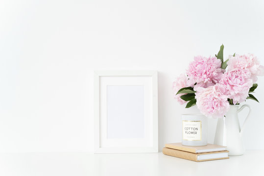 Stylish white a5 blank frame mockup. Still life composition, floral bouquet of pink peonies in jug. White background, mock up for quote, promotion, headline, design, and social media