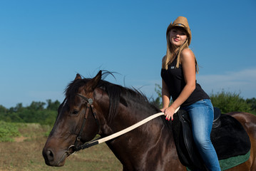 Fototapeta premium Young beautiful girl with a horse on nature