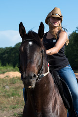 Obraz premium Young beautiful girl with a horse on nature
