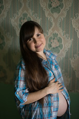 Portrait of a young beautiful pregnant girl