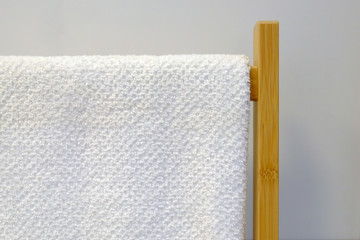 Clean Colored towels hanging on the rack in the bathroom. Focus on the top of the hook and towels